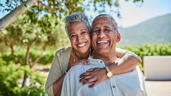 Portrait of elderly man and woman together for fresh air and tree view on vacation.